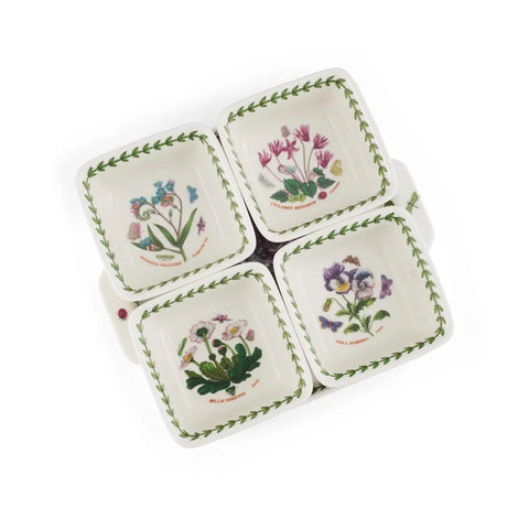 Four small square ceramic dishes with rounded corners arranged in a square pattern on a white background. Each dish features a different colorful botanical flower illustration and a green leafy border around the rim.