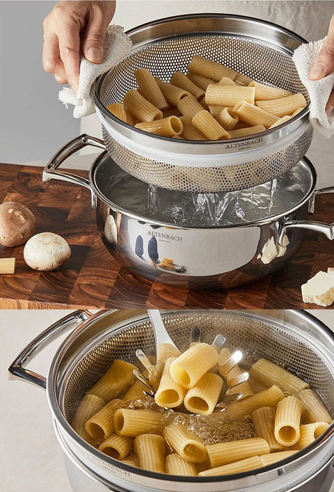 Pasta being drained in a stainless steel colander over a pot on a wooden surface.