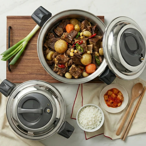 Stew in a pot with vegetables and a small plate of food on a table.