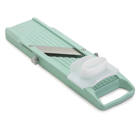 Mint green vegetable mandoline slicer on a white background