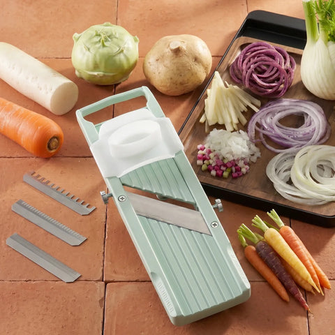 Vegetable slicer with sliced vegetables on a wooden surface