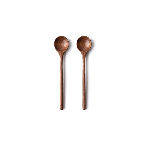Two wooden spoons on a white background