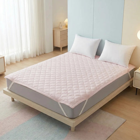 Mattress pad with a quilted cover in a bedroom setting