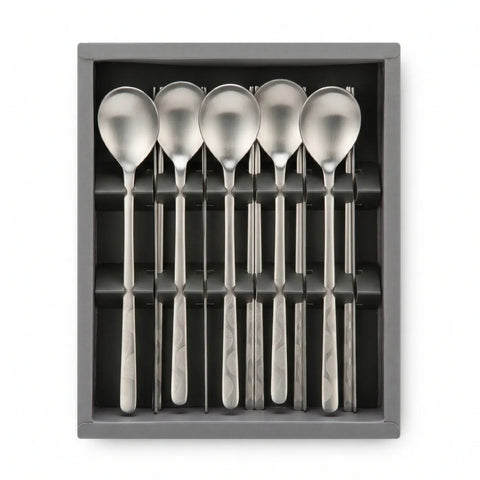 Set of six silver spoons and chopsticks in a gray box