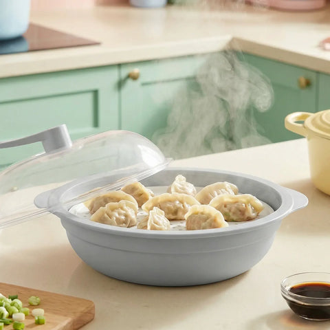 Gray steamer basket with dumplings on a kitchen counter