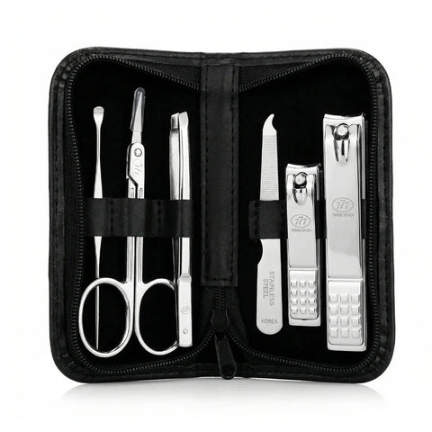 Manicure set with scissors, clippers, and tweezers in a black case on a white background