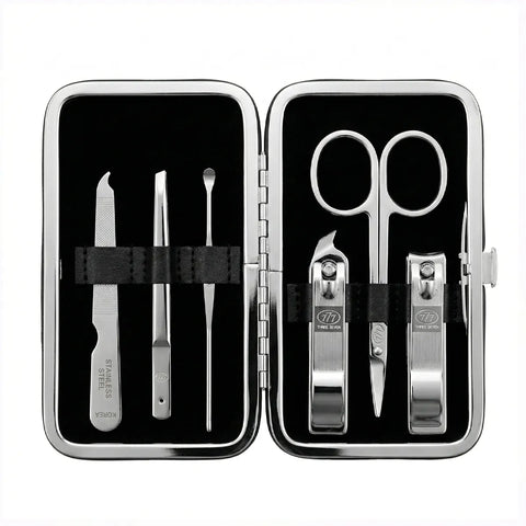 Manicure set with scissors, clippers, and tweezers in a black case on a white background
