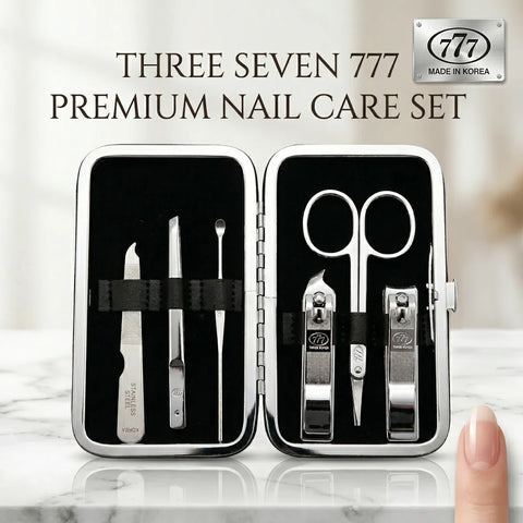 Three Seven 777 premium nail care set with tools in a black case on a marble surface.