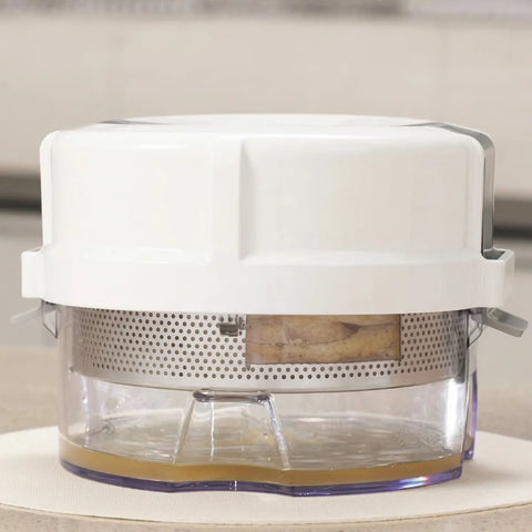 White kitchen appliance with a clear container on a light surface