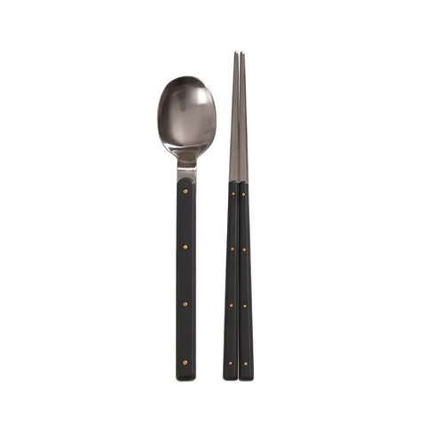 Spoon and chopsticks with black handles on a white background
