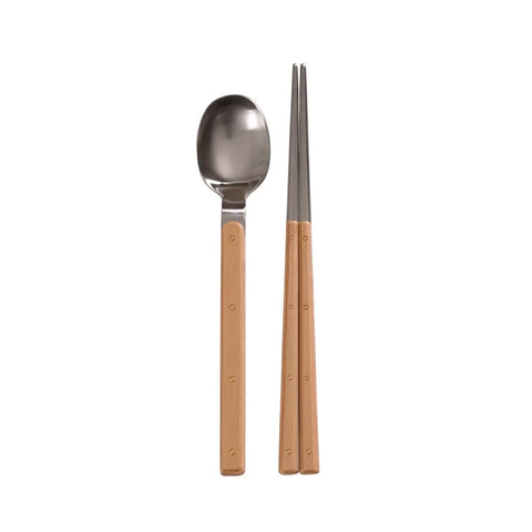 Stainless steel spoon and chopsticks with brown handles on a white background