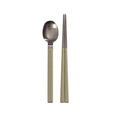 Stainless steel spoon and chopsticks with green handles on a white background