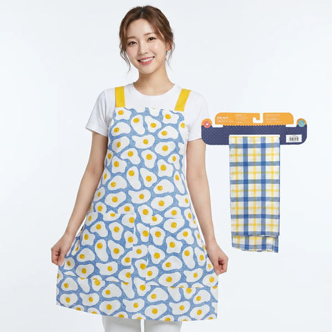 Woman wearing a blue apron with egg pattern, next to a matching towel on a white background