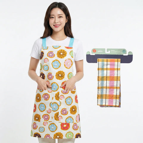 Woman wearing a colorful apron with a donut pattern, next to a folded plaid towel on a white background.