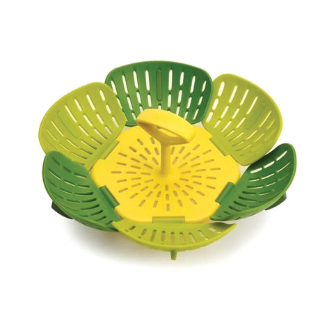 Yellow and green kitchen steamer basket on a white background