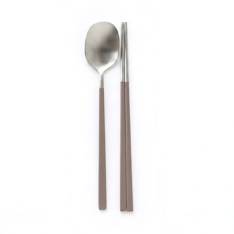 Stainless steel spoon and chopsticks on a white background