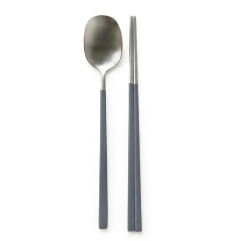 Spoon and chopsticks with gray handles on a white background