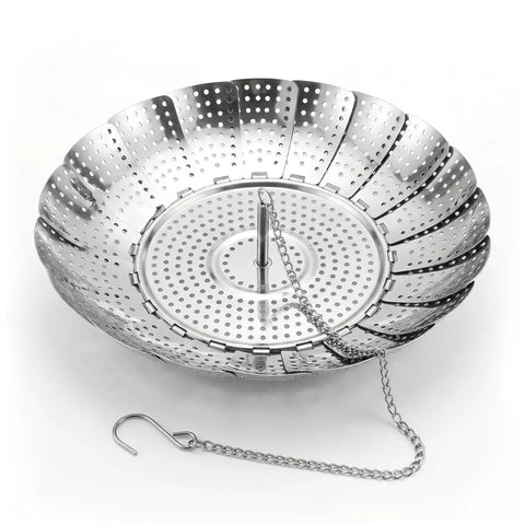 Metallic steamer basket with perforations on a white background