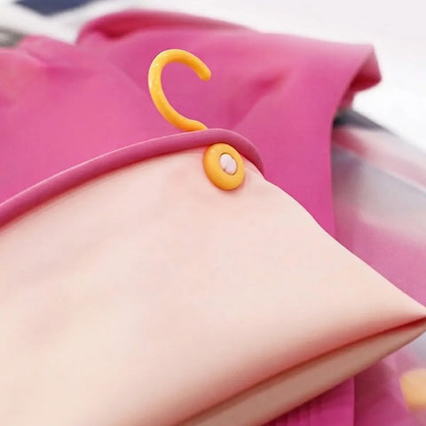 Pink fabric with a yellow hanger on a blurred background