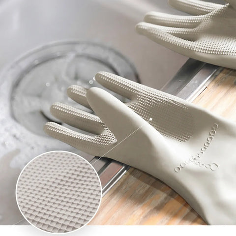 Beige cleaning gloves with textured surface on a kitchen counter.