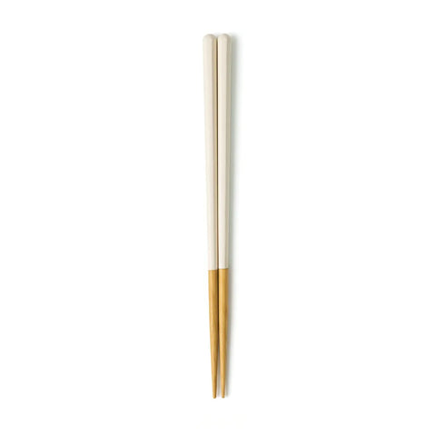 Pair of white and wooden chopsticks on a white background