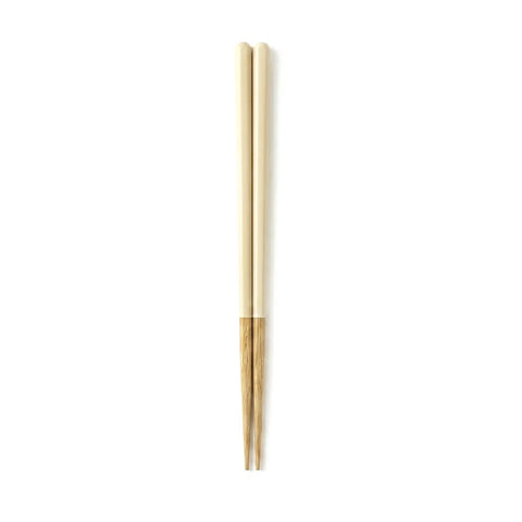 Pair of beige and wooden chopsticks on a white background