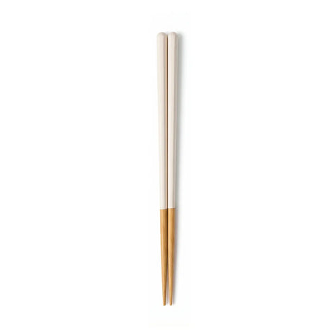 Pair of white and wooden chopsticks on a white background