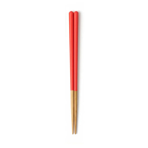 Pair of red and gold chopsticks on a white background