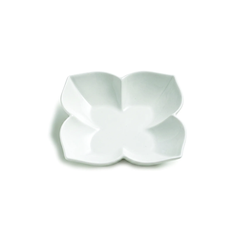 A white ceramic four-petal flower-shaped bowl or dish, photographed from directly above on a clean white background.