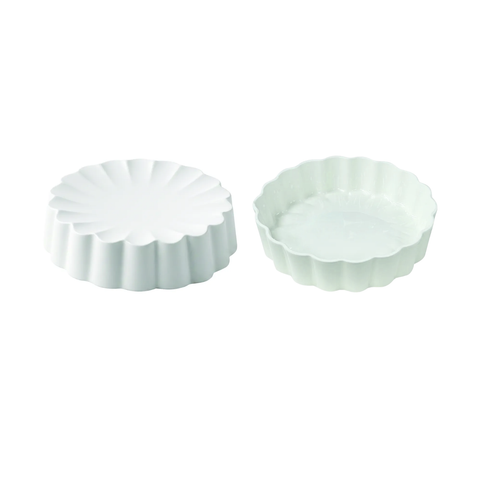 Two small round scalloped tart pans in a very pale mint green color, shown on a plain white background.
