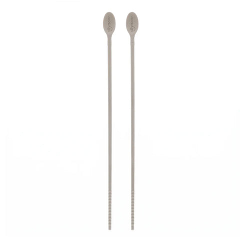 Gray silicone cooking chopsticks with a spoon head on one end on a white background