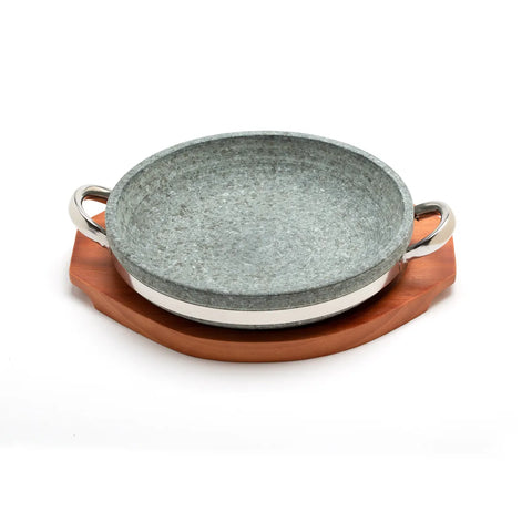 Stone bowl with stainless steel handles with wooden base on a white background