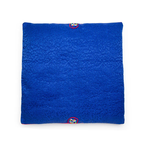 Blue textured square seat cushion with an embroidered design on a white background