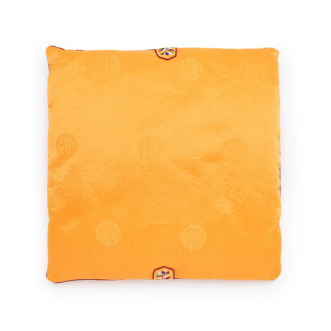 Yellow square seat cushion with embroidered patterns on a white background