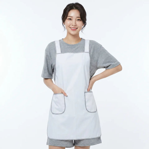 Person wearing a white apron over a gray outfit on a white background