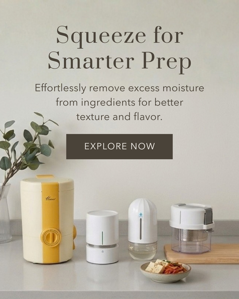 A countertop scene showing several small kitchen appliance devices in white and yellow tones, with a small bowl of ingredients and a wooden board. Large text reads 'Squeeze for Smarter Prep' with a dark 'EXPLORE NOW' button on a light beige background.