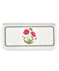 A white rectangular ceramic serving tray with side handles, featuring a botanical design of red poppies, green leaves, and butterflies, bordered by a green leaf pattern.