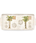 A rectangular decorative tray with rounded corners and side handles, featuring two illustrated palm trees, ornate medallions, and faint cursive script on a warm off-white background.