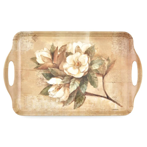 A rectangular decorative tray with rounded corners and integrated side handles, featuring a vintage-style floral print of white magnolia blossoms with green leaves on a distressed beige background.
