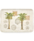 A rectangular decorative serving tray with integrated side handles, featuring two illustrated palm trees, ornate gold-toned medallions, and a distressed beige script background.