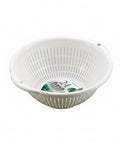 A white plastic colander bowl with vertical slits and two side handles, shown on a smooth gray gradient background. The inside bottom features a circular paper label with '24 fresh' visible.