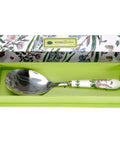 Spoon with floral handle in a green box, against a white background