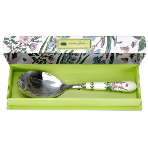 Spoon with floral handle in a green box, against a white background