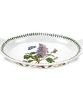 Decorative white dish with floral and butterfly design on a white background