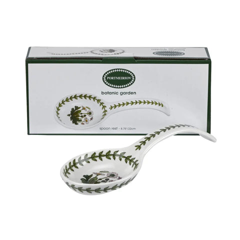A white ceramic spoon with a green botanical leaf pattern, shown in front of its white and green Portmeillon packaging box on a white background.