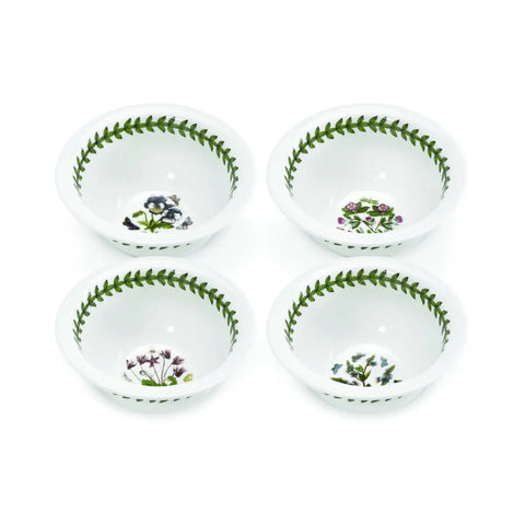 Four white ceramic bowls arranged in a 2x2 grid, each decorated with a green leaf border and a small floral motif inside, on a plain white background.