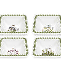 Four white decorative plates with floral designs on a white background
