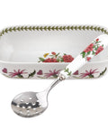 Rectangular ceramic dish with floral design and matching spoon on a white background