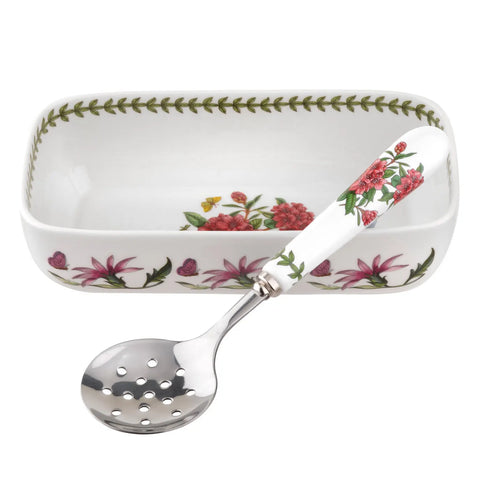 Rectangular ceramic dish with floral design and matching spoon on a white background