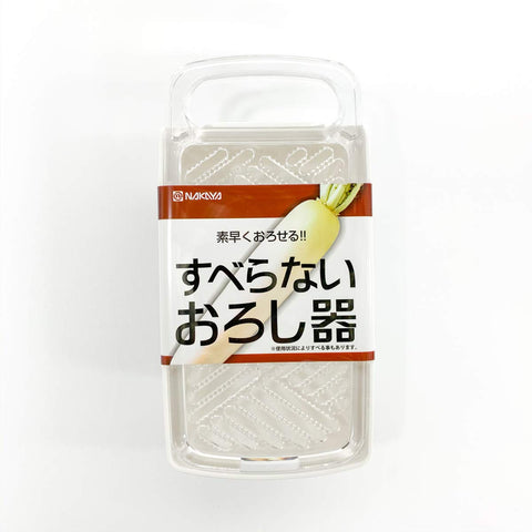A packaged Japanese mandoline slicer by Nakaya, shown in its clear plastic retail packaging with a white and brown paper label featuring a daikon radish illustration.